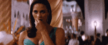 a woman in a blue dress covering her mouth