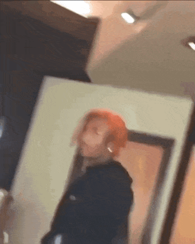a blurry picture of a person standing in a room with a door .