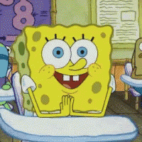 a cartoon spongebob sits at a desk with his hands together
