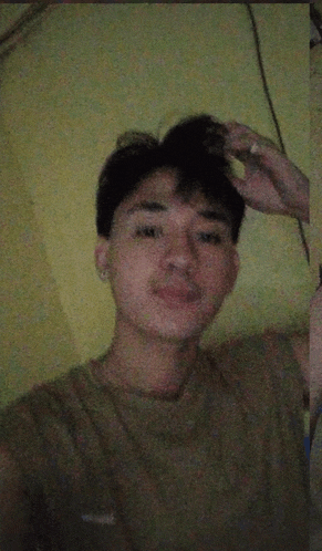 a young man taking a selfie with a cigarette in his mouth