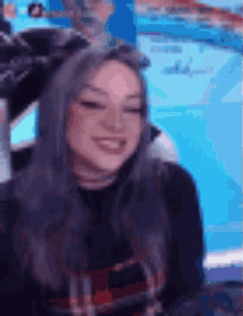 a blurry picture of a woman with gray hair smiling