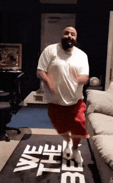 a man is jumping on a mat that says we the best on it