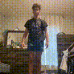 a blurry picture of a person standing in front of a dresser