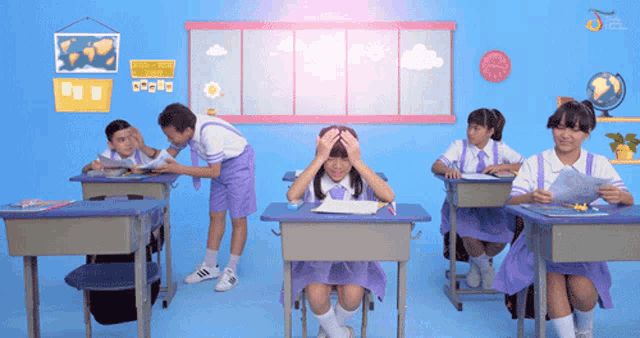 a girl with her hands on her head sits in a classroom with other students