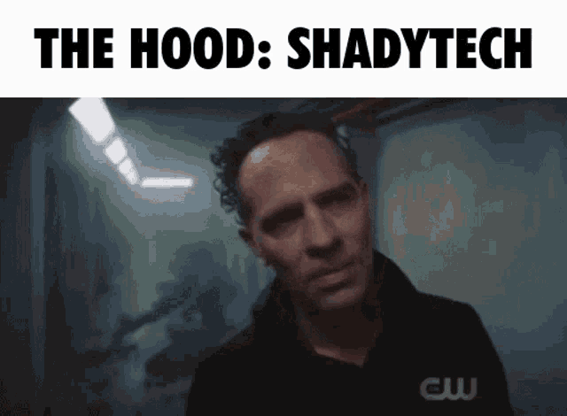 a man in a dark room with the words the hood shadytech on the top