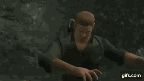 a woman in a video game is kneeling down next to a man .