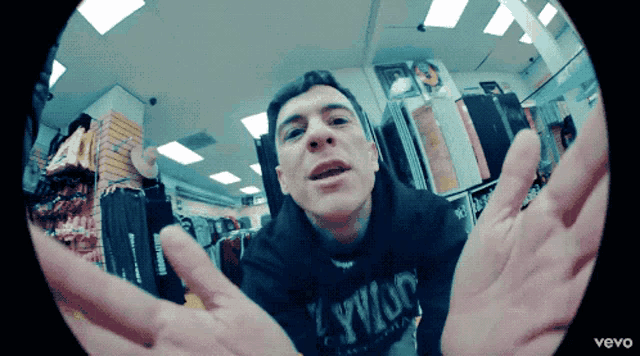 a man wearing a hoodie that says l.y.w.o.p.
