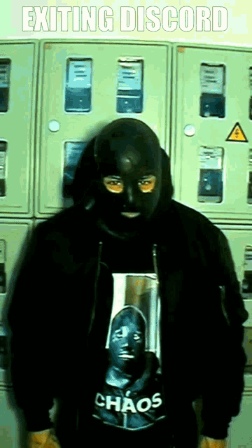 a man wearing a mask and a chaos shirt