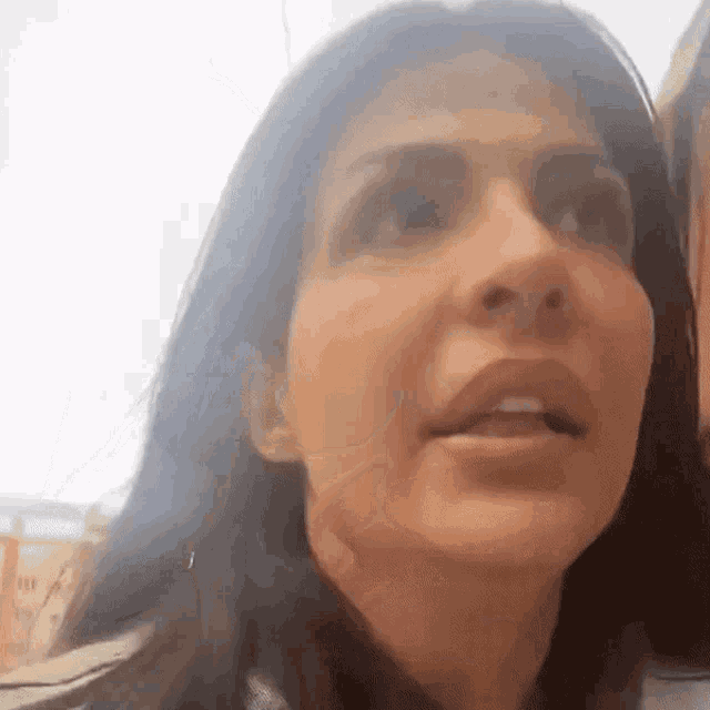 a close up of a woman 's face with a very serious look on her face