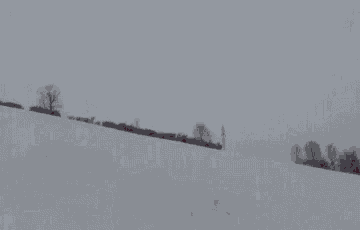 a person is skiing down a snow covered hill