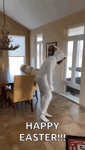 a person in a white bunny suit is jumping in a living room .