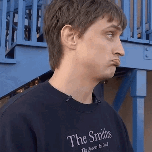 a man wearing a shirt that says the smiths the queen is dead