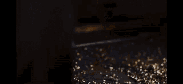 a close up of a person 's foot on a table with gold glitter .