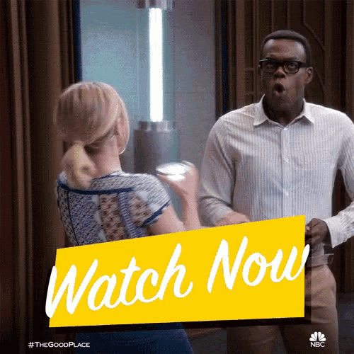 a man and woman standing next to each other with a yellow sign that says " watch now "