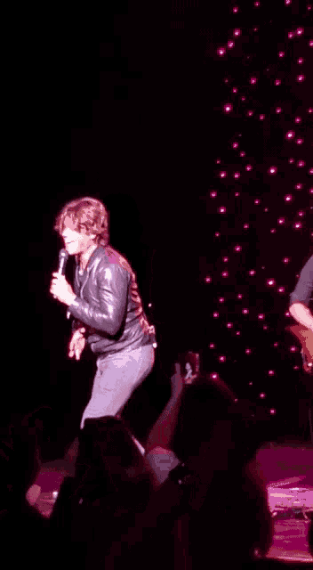 a man on a stage with a jacket that says " i love you " on it