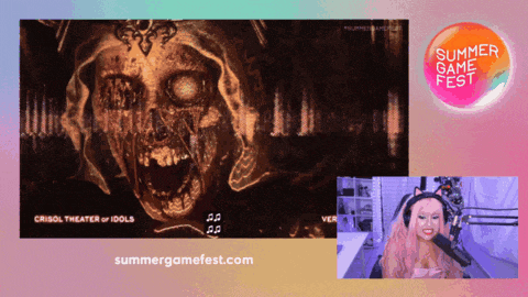 a woman sitting in front of a screen with the words summer game fest