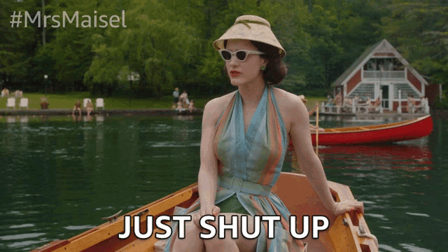 a woman sitting in a boat with the words just shut up above her