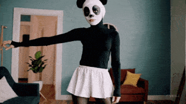 a woman wearing a panda mask and a black top