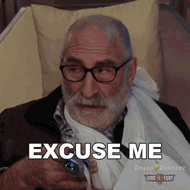 a man with glasses and a bandage on his arm is holding a device and says excuse me