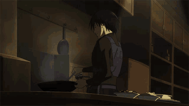 a man in a purple vest is cooking food in a dark kitchen