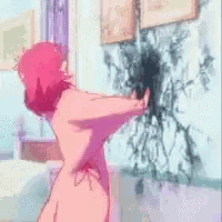 a naked woman is standing in front of a wall with a spider on it