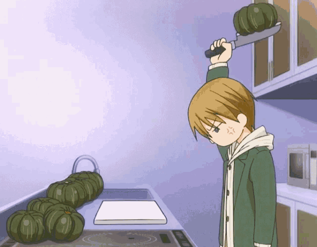 a boy is holding a knife over his head while cutting a pumpkin