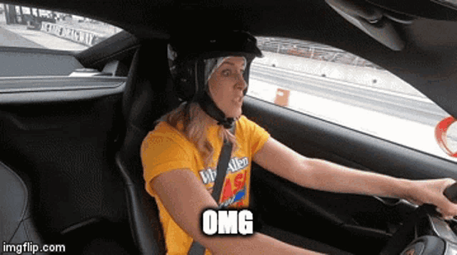 a woman wearing a helmet and a yellow shirt is driving a car with the word omg above her