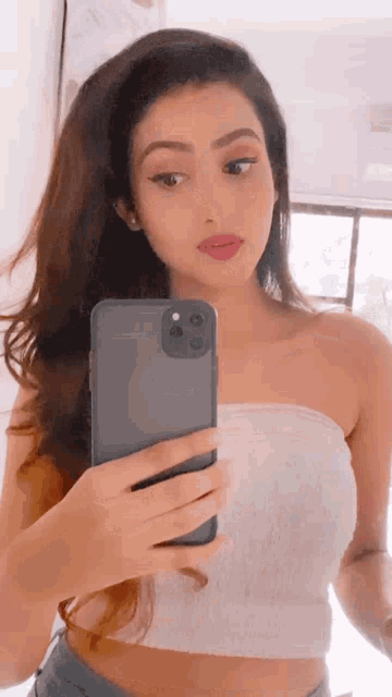 a woman is taking a selfie with her cell phone