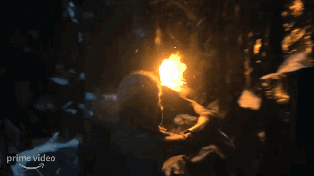 a person is holding a torch in a dark room with a prime video logo in the corner