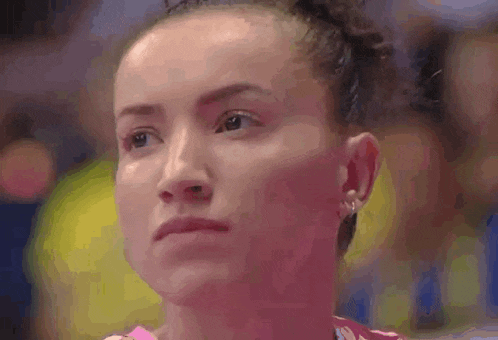 a close up of a woman 's face with a pink background