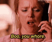 a woman is talking on a cell phone and says boo you whore .