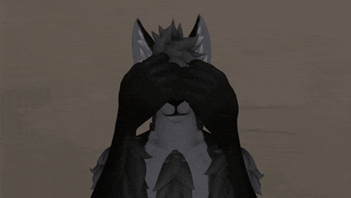 a furry animal is covering its eyes with its paws