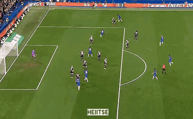 a soccer game is being played on a field with a sign that says heitse