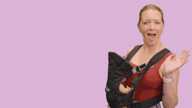 a woman holding a baby in a carrier with the words thanks baby