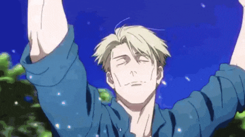a man in a blue shirt is standing in front of a blue sky with his arms in the air .