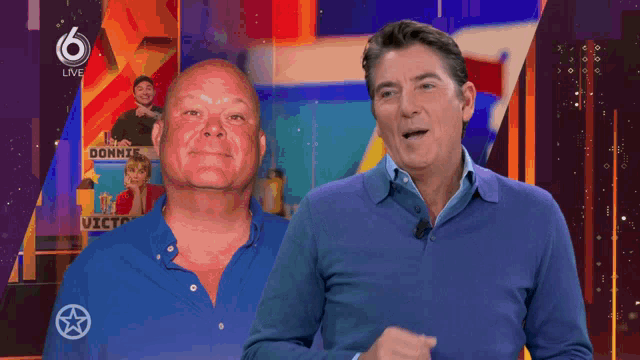 two men standing in front of a sign that says 6 live