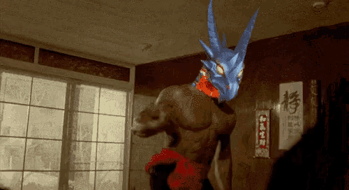 a man with a dragon on his head is standing in a room
