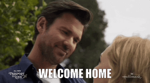a man and woman are looking into each other 's eyes and the words welcome home are visible