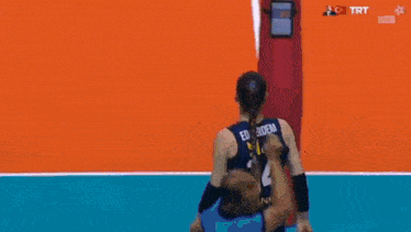 a female volleyball player is kneeling down on the court .