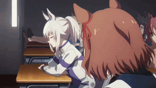 a girl with a ponytail is sitting at a desk
