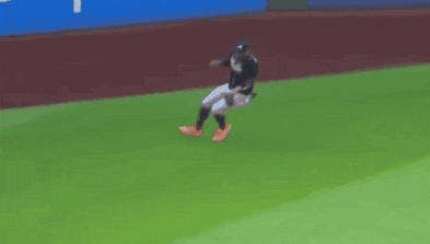 a baseball player is laying on the field with his feet up