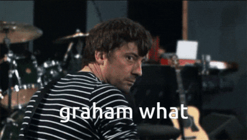 a man in a striped shirt says graham what in front of drums