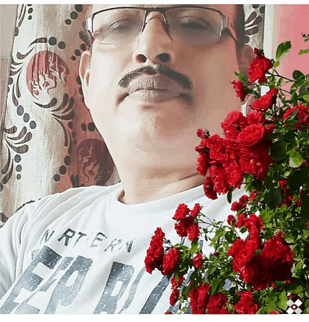 a man wearing glasses and a shirt that says n.r.t.e.r.a.