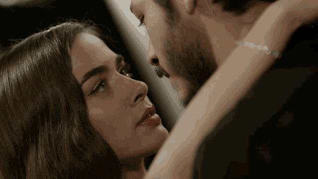 a man and a woman are looking at each other