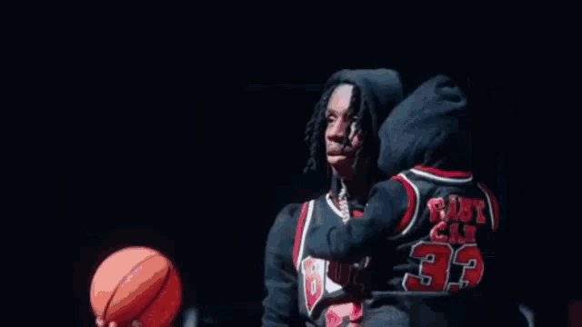 a basketball is going through a basketball hoop in a gym .