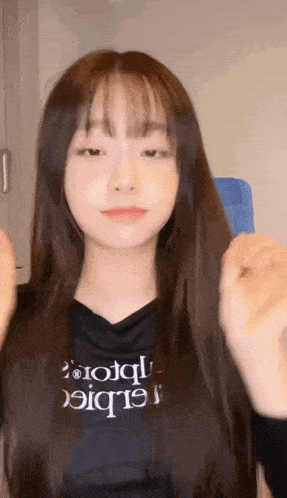 a girl with long hair is wearing a black shirt that says ' rototq ' on it