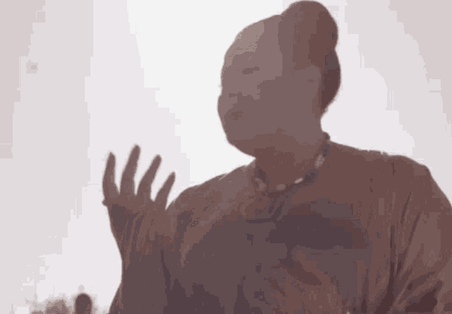 a silhouette of a woman wearing a necklace and a t-shirt that says ' hawaii '