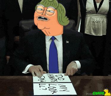 a man in a suit and tie is sitting at a desk with a sign that says " do my hair look small "