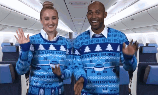 a man and a woman are wearing sweaters that say flying home for christmas