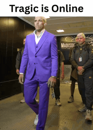 a man in a purple suit is walking down a hallway with a sign that says madison